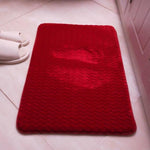 Couleur rouge de ce tapis de bain