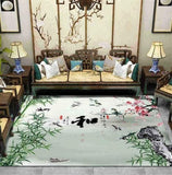 Tapis de salon motifs japonais fin et délicat, sur ton vert d'eau avec écriture japonaisse en noir, oiseau et bambou présenté avec un canapé en rotin